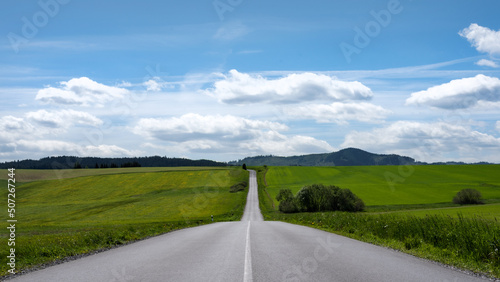 The asphalt road across a beautiful landscape.