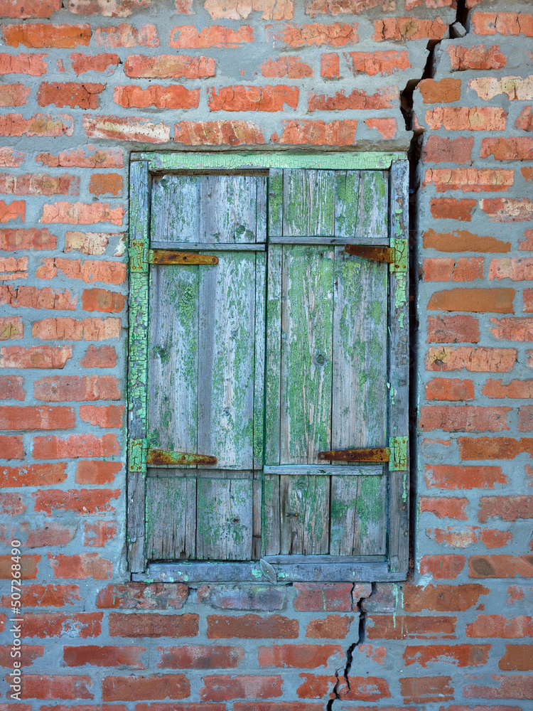 Vertical photo of an old brick wall with a crack Vertical photo of an old brick wall with a crack