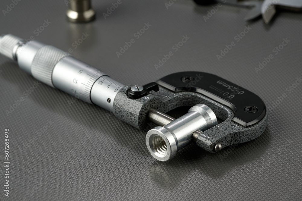 Closeup of a mechanical micrometer with a steel sleeve. Closeup of a mechanical micrometer with a steel sleeve.