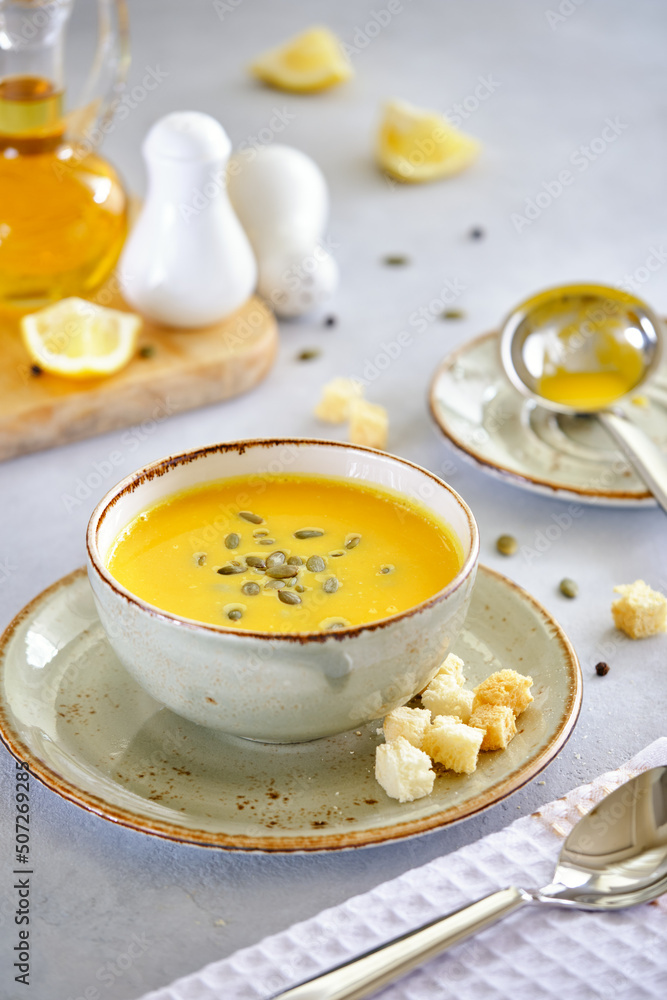 Tasty and healthy dietary food. Pumpkin soup cream on a gray background Tasty and healthy dietary food. Pumpkin soup cream on a gray background