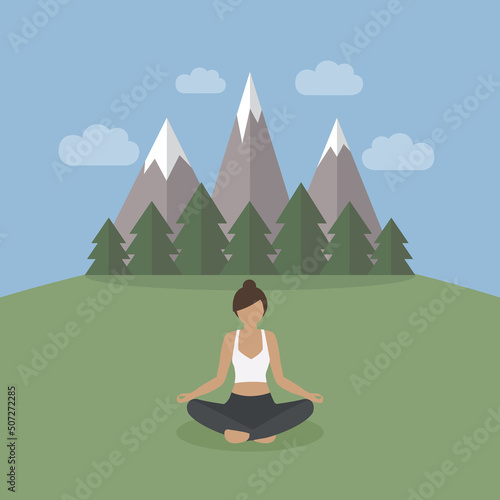 girl makes yoga on green mountain landscape