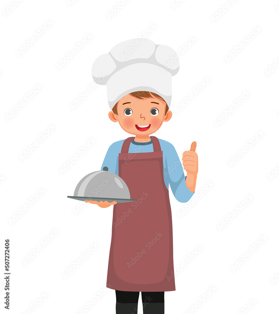 cute little boy in chef hat and apron holding a tray showing thumb up cute little boy in chef hat and apron holding a tray showing thumb up