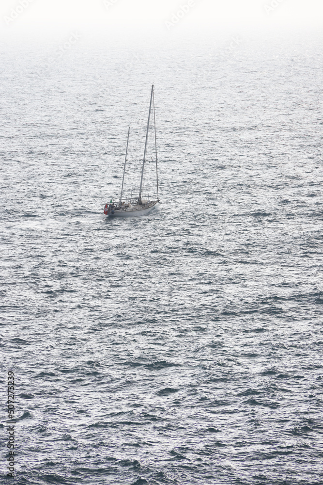 Lonely sailing boat on the sea of Liguria, Italy Lonely sailing boat on the sea of Liguria, Italy