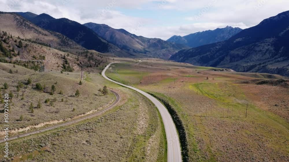 Drone revealing a car driving through mountain highway Drone revealing a car driving through mountain highway
