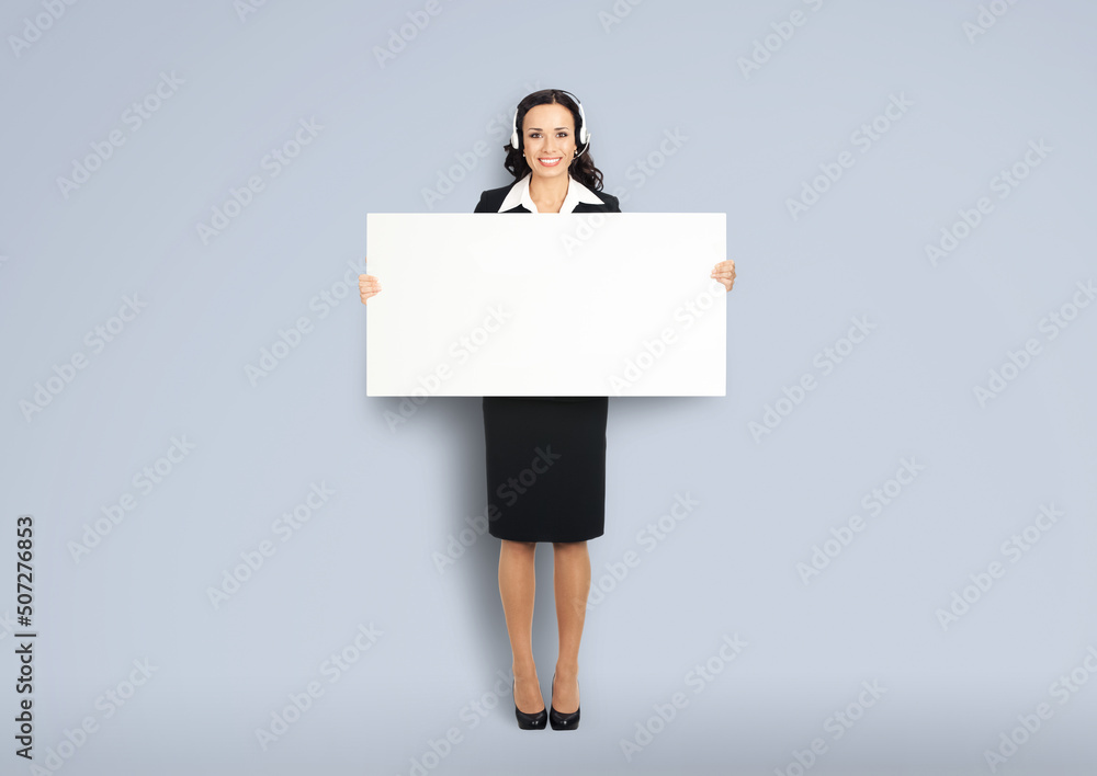 Call Center Service. Customer support or sales agent. Businesswoman or caller phone operator holding white banner. Full body of business woman in headset with empty signboard. Help answering concept. Call Center Service. Customer support or sales agent. Businesswoman or caller phone operator holding white banner. Full body of business woman in headset with empty signboard. Help answering concept.