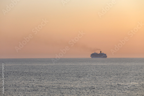 Fototapeta Naklejka Na Ścianę i Meble -  Passenger ship crossing the sea at sunset