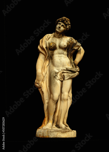Antique Olympic goddess of love and beauty Aphrodite (Venus) Fragment of ancient statue isolated on black background.