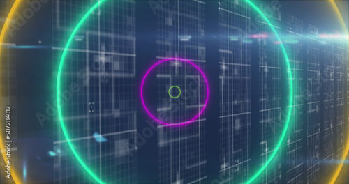 Image of neon circles over data processing on navy background