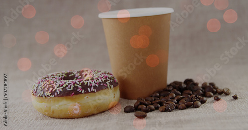 Image of coffee and donut over light spots