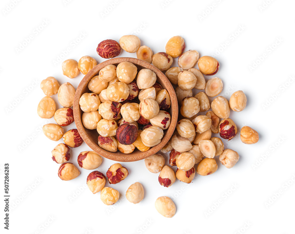 Hazelnut kernels in a wooden bowl isolated on a white background. Top view Hazelnut kernels in a wooden bowl isolated on a white background. Top view