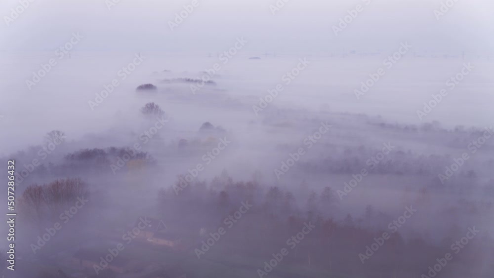 Dark moody feeling in forestry landscape covered in dense fog, aerial view Dark moody feeling in forestry landscape covered in dense fog, aerial view