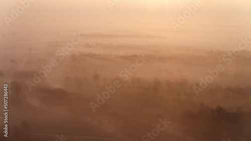 Dense fog over forestry landscape with shining sun, happy inspirational mood photo