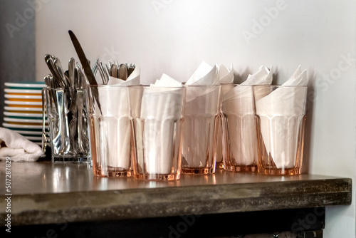 clean dishes on tabletop of counter in coffee bar or restaurant
