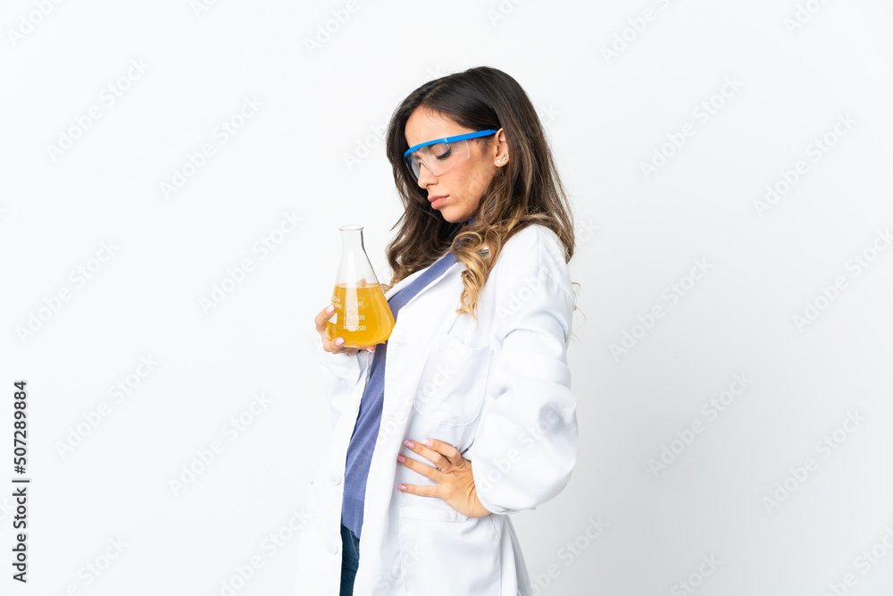 Young scientific woman isolated on white background suffering from backache for having made an effort Young scientific woman isolated on white background suffering from backache for having made an effort