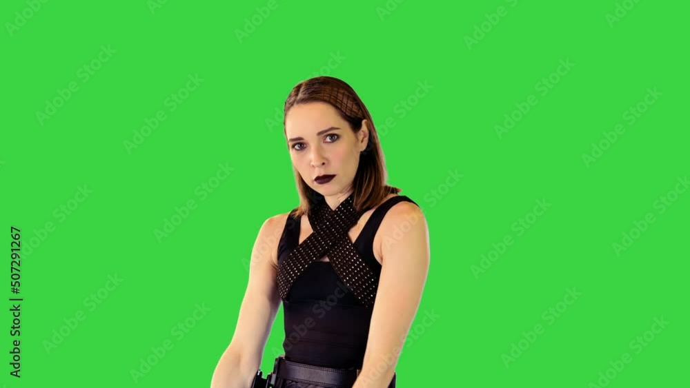 Shooter-character girl gets a gun out of holster and takes an aim on a Green Screen, Chroma Key. Shooter-character girl gets a gun out of holster and takes an aim on a Green Screen, Chroma Key.