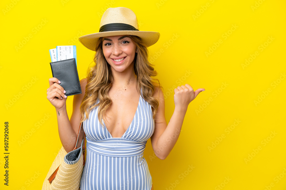 Young woman goes on vacation to the beach isolated on yellow background pointing to the side to present a product Young woman goes on vacation to the beach isolated on yellow background pointing to the side to present a product