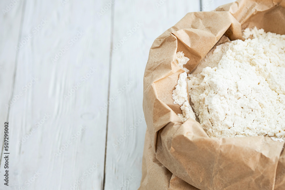 Wheat flour in paper pack, close up. Wheat flour in paper pack, close up.