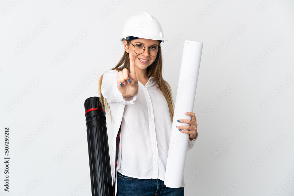 Young Lithuanian architect woman with helmet and holding blueprints isolated on white background showing and lifting a finger