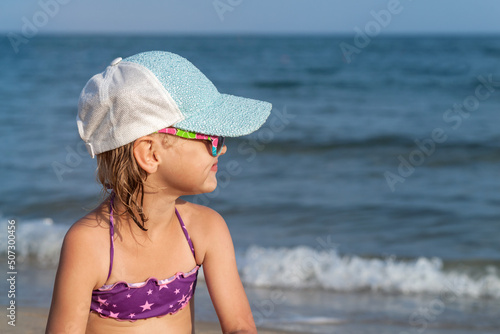 Children Enjoing Sea View. Happy Child Looking at Sea. Side View Little Girl on Sea Waves Background. Summer Sea Vacation concept.
