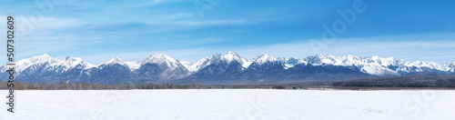 Winter landscape panorama with Sayan Mountains in Siberia on sunny winter day. Natural background. © LanaUst