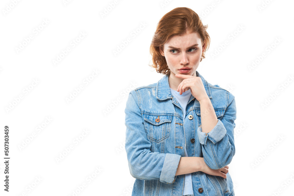 Smart redhead girl in casual holding chin thinks doubts, makes decision isolated on white studio background Smart redhead girl in casual holding chin thinks doubts, makes decision isolated on white studio background