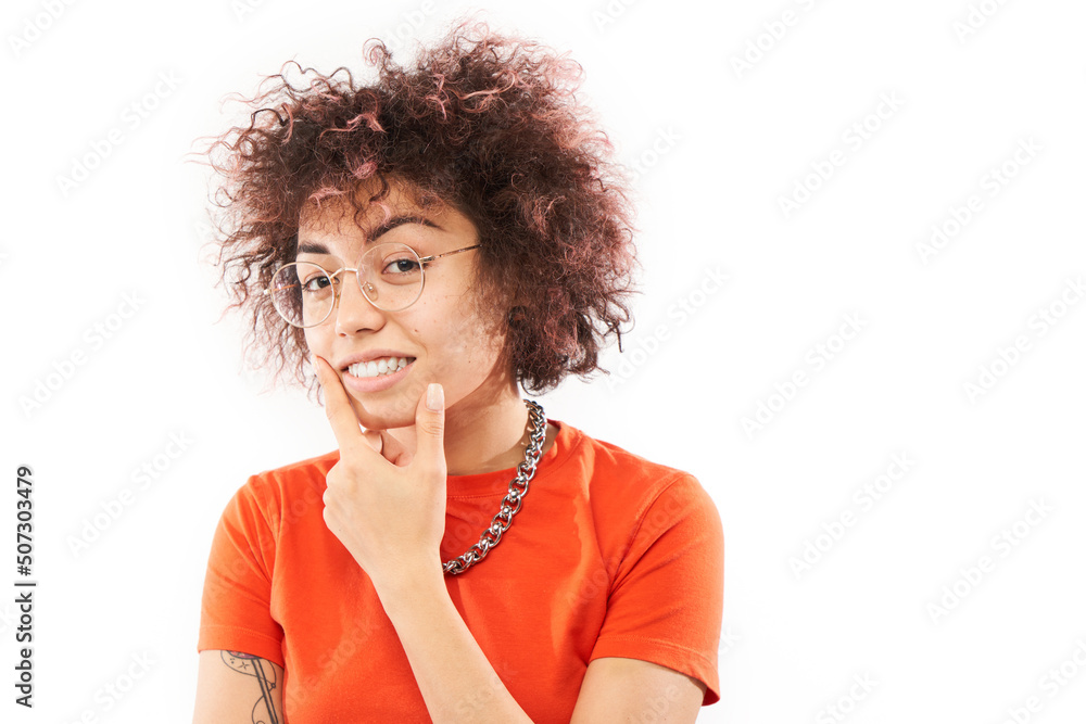 Funny curly girl holding her chin thinks doubts, makes decision isolated on white studio background - obrazy, fototapety, plakaty 