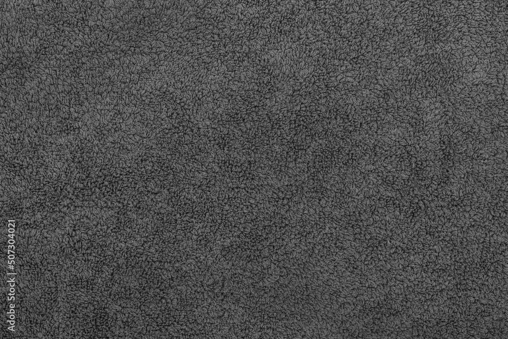 Fototapeta premium Black fabric soft texture of a terry towel close-up.