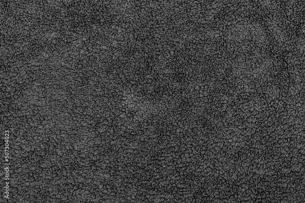 Fototapeta premium Black fabric soft texture of a terry towel close-up.