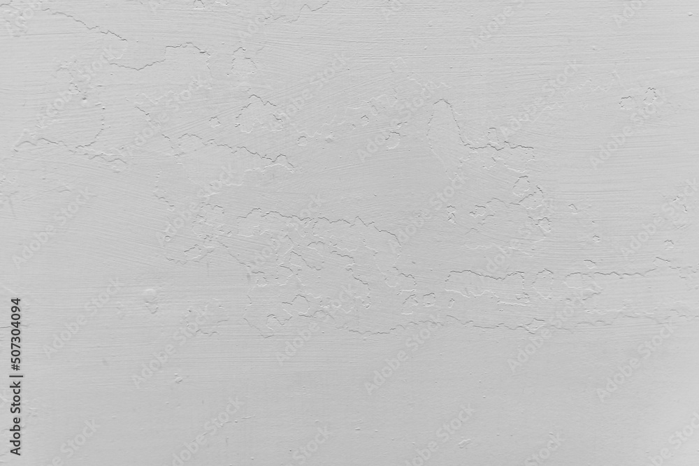 Fototapeta premium white wall with pieces of peeling plaster background texture