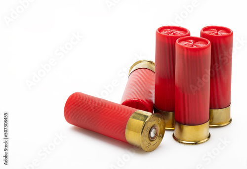 Red shotgun bullet shells on white background , Gun shooting game photo