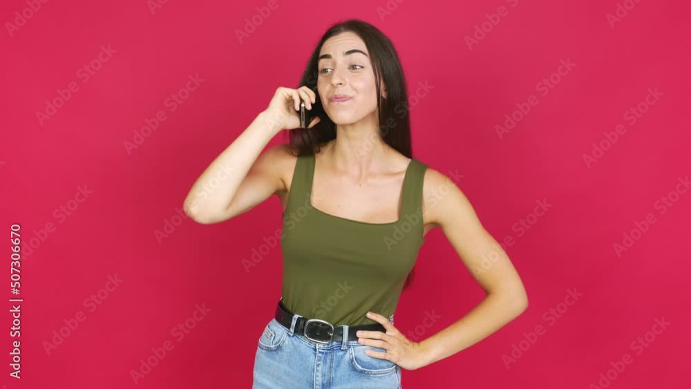 Young brunette woman using mobile phone over isolated background Young brunette woman using mobile phone over isolated background