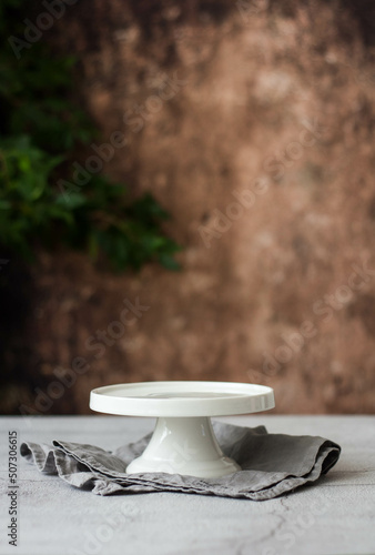 Fototapeta Empty White Cake Stand on the background of an old wall