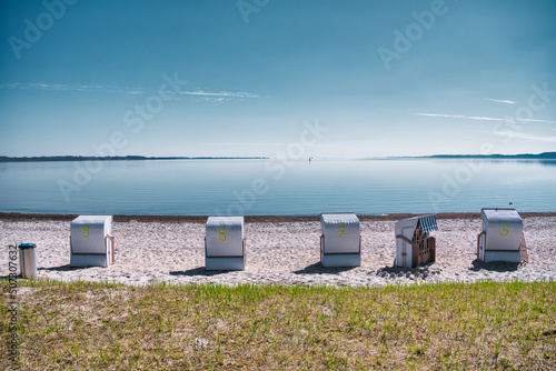 Fototapeta Naklejka Na Ścianę i Meble -  Beach chairs in Flensburg fjord between Denmark and Germany