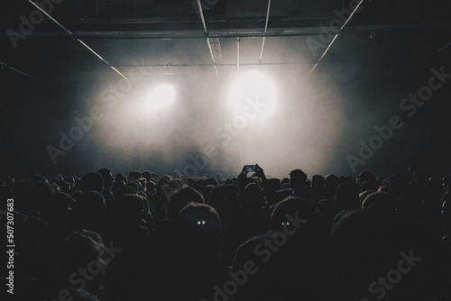 Fototapeta at a concert in a crowd facing the stage