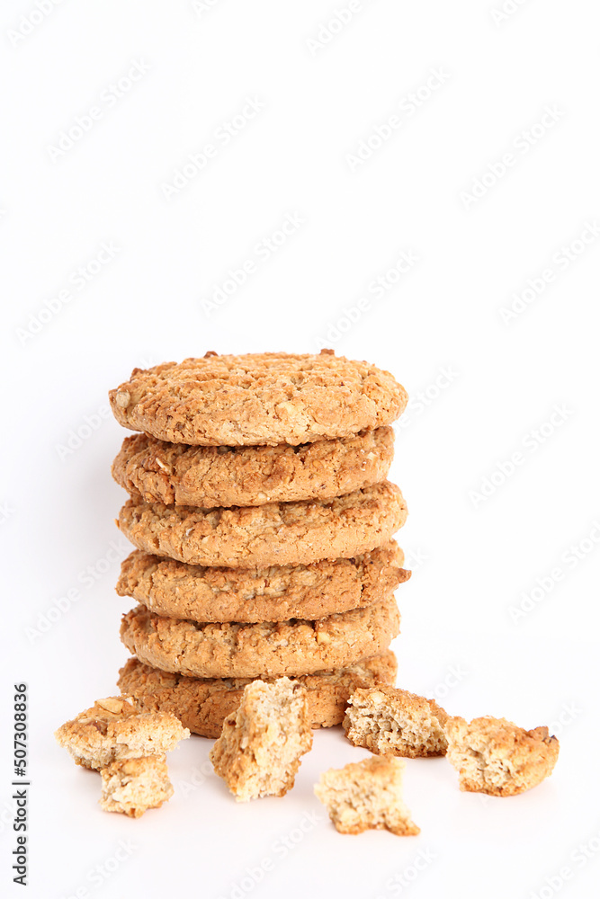 Oatmeal, fig, hazelnut, pistachio and sesame cookies on a white background. Enjoyable snack. Oatmeal, fig, hazelnut, pistachio and sesame cookies on a white background. Enjoyable snack.