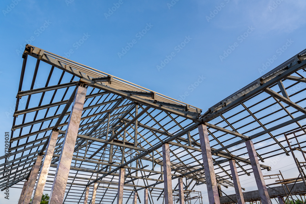 Roof structure of steel for building or house under construction on sky background.