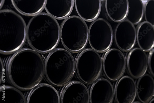 steel profile materials used in industry. stacked iron pipes. Selective focus middle pipe