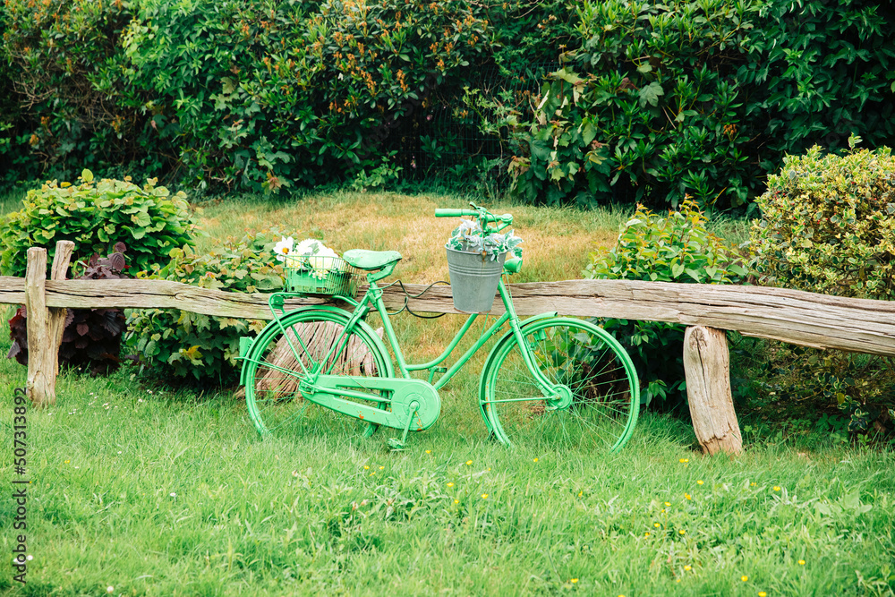 Green bike in nature. Bicycle decorated with flowers. decoration in the country. spring mood.