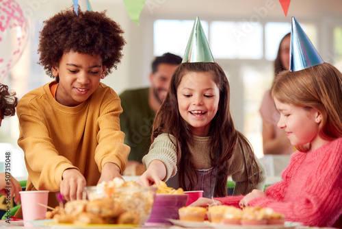 Photography Girl With Parents And Friends At Home Celebrating Birthday Eating Snacks At Part