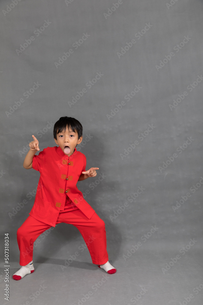 little boy fashion Smiling child in red chinese dress, style and fashion ideas for children.