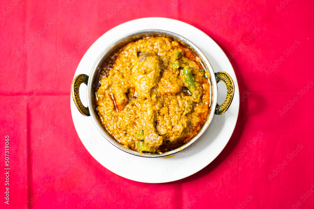 Chicken karahi, indian spicy chicken masala isolated on background top view of pakistani chic Chicken karahi, indian spicy chicken masala isolated on background top view of pakistani chic