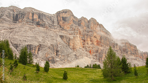 East face of Sasso di Santa Croce mountain range in the eastern Dolomites, its 900 meters vertical wall and Mount Cavallo, seen from Roda de Armentara trail to St. Croce refuge, South Tyrol, Italy photo