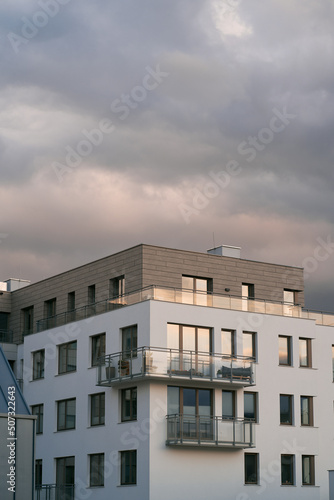 Exterior of a modern condominium. Residential area with ecological and sustainable green residential buildings, low-energy houses with apartments and green courtyard