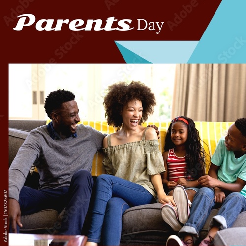 Parents day text with cheerful african american parents sitting by son and daughter on sofa