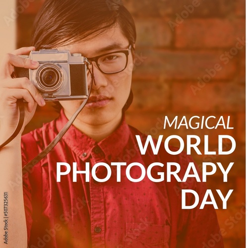 Magical world photography day text banner against asian male photographer using digital camera
