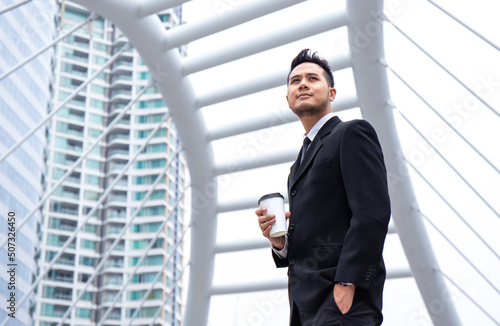 success happy businessman manager drink coffee in paper cup in morning at center of modern business office in downtown