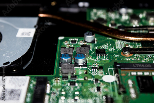 computer hard drive circuit board with capacitors electronic wires being serviced and repaired