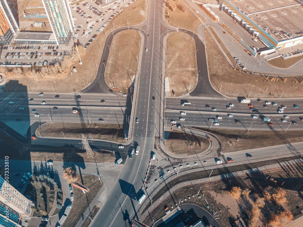 Obraz premium City crossroads and overpasses with traffic aerial view. Transport in the busy city concept