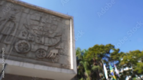 Out of focus building with concrete artwork and blue sky photo