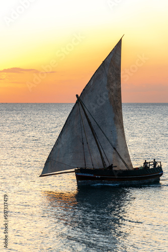 heavy powerful african dhow sailing on the evening tide